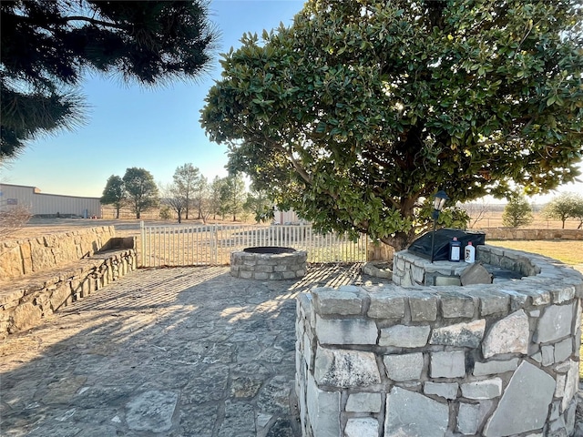 exterior space featuring a patio, fence, and a fire pit