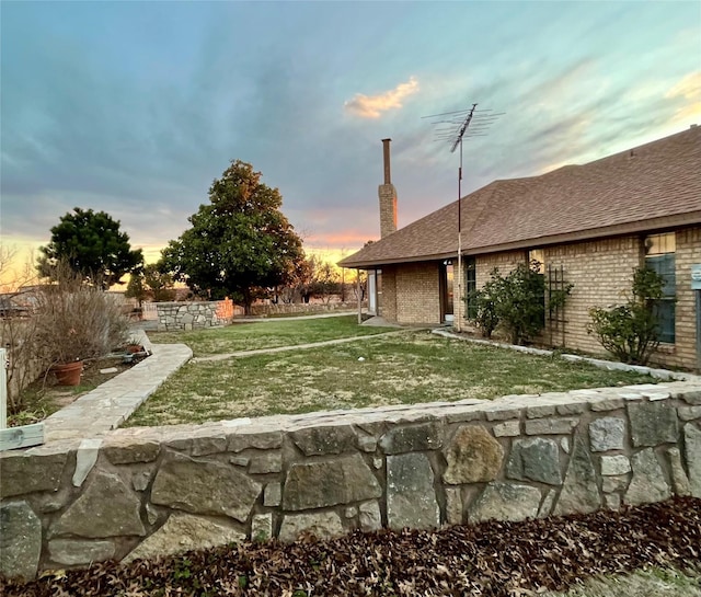 view of yard at dusk