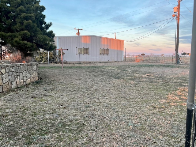 view of yard featuring an outdoor structure, a pole building, and fence