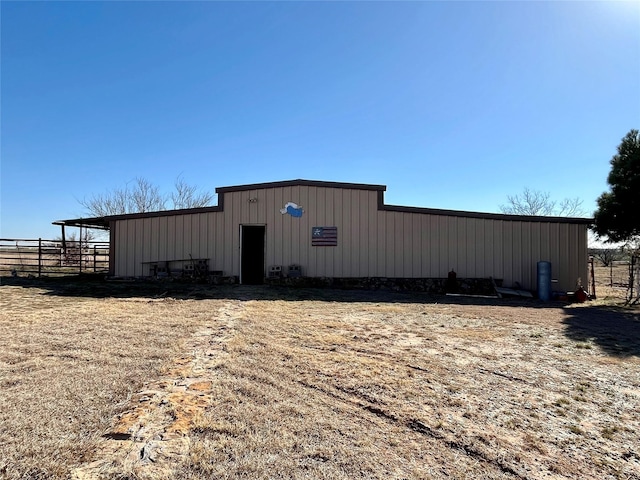 view of pole building with fence