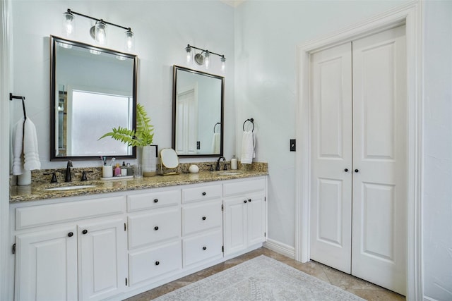 bathroom featuring double vanity, tile patterned flooring, and a sink