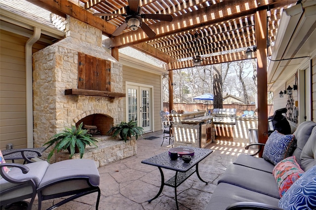 view of patio / terrace featuring french doors, an outdoor living space with a fireplace, ceiling fan, fence, and a pergola