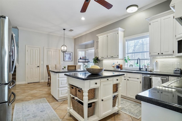 kitchen featuring appliances with stainless steel finishes, dark countertops, and a kitchen island