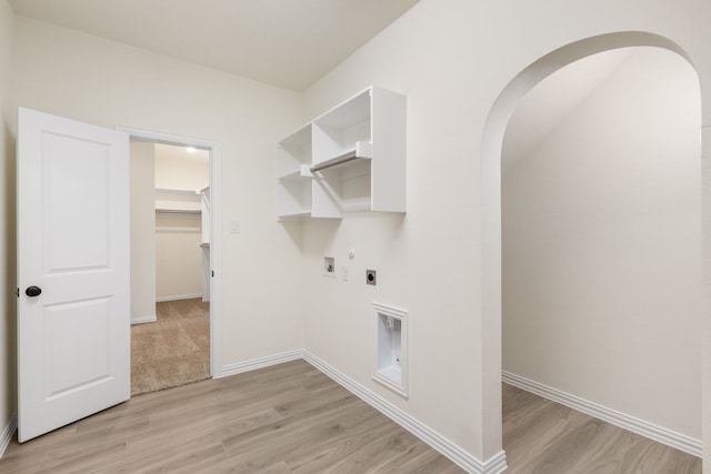 clothes washing area featuring hookup for a washing machine, light wood-style flooring, hookup for an electric dryer, laundry area, and baseboards