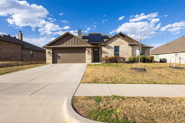 ranch-style home with brick siding, board and batten siding, driveway, and a front lawn