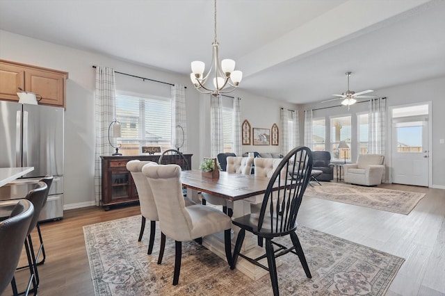 dining area featuring a notable chandelier, baseboards, and wood finished floors