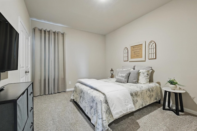 bedroom with light carpet and baseboards