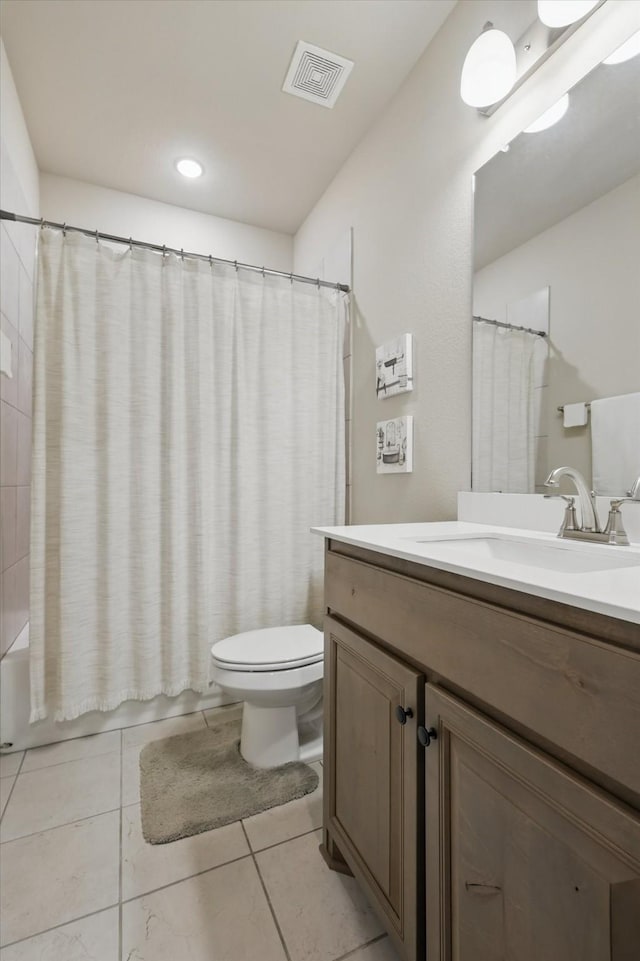 bathroom with visible vents, toilet, shower / bath combo with shower curtain, vanity, and tile patterned flooring