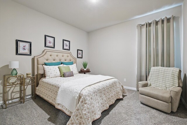 bedroom featuring carpet floors and baseboards