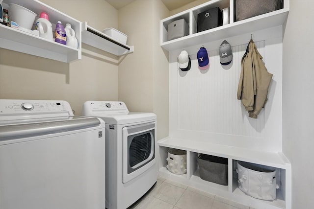 laundry area featuring laundry area, washer and clothes dryer, and light tile patterned floors