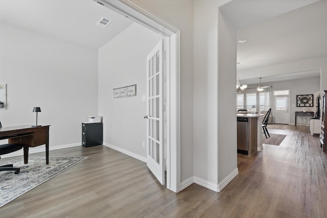 office with visible vents, baseboards, and wood finished floors