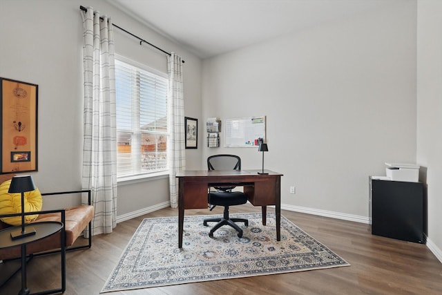 office space featuring wood finished floors, a wealth of natural light, and baseboards