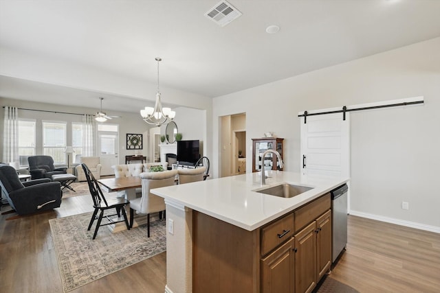 kitchen with open floor plan, visible vents, a sink, and a barn door