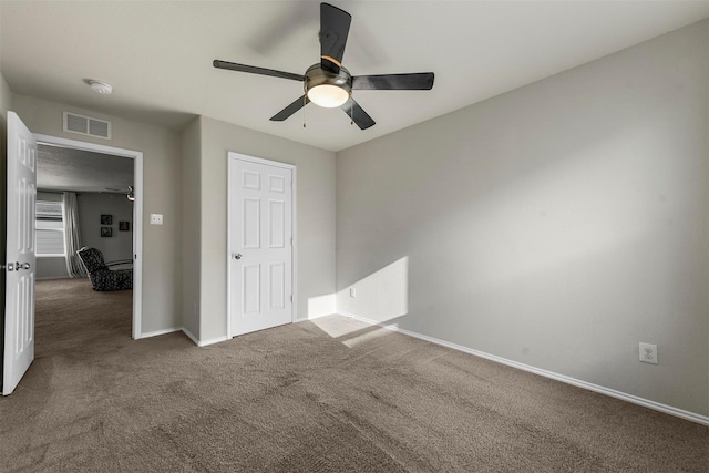 unfurnished bedroom with ceiling fan, carpet floors, visible vents, and baseboards