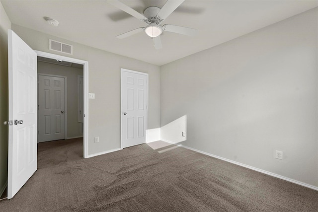 unfurnished bedroom featuring a ceiling fan, baseboards, visible vents, and carpet flooring