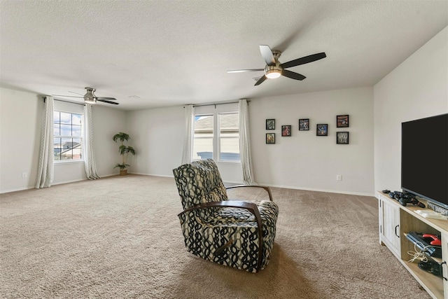 sitting room with a textured ceiling, ceiling fan, carpet, and a wealth of natural light