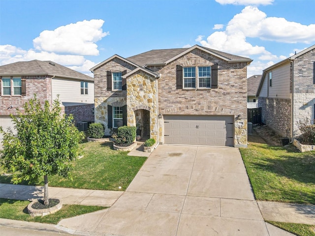 traditional home featuring a front yard, concrete driveway, brick siding, and an attached garage