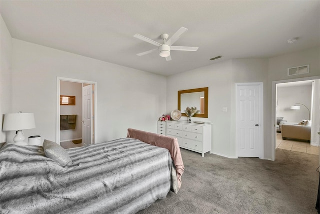 bedroom featuring visible vents, a ceiling fan, and light colored carpet