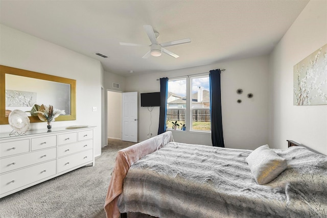 bedroom with ceiling fan, visible vents, and light colored carpet