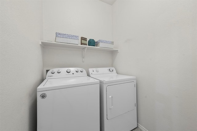 laundry room with laundry area and washing machine and clothes dryer