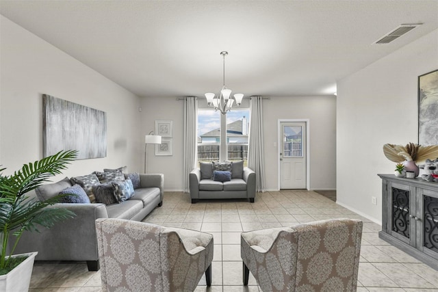 living area featuring a chandelier, visible vents, baseboards, and light tile patterned flooring