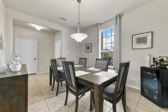 dining area with beverage cooler, visible vents, baseboards, and light tile patterned flooring