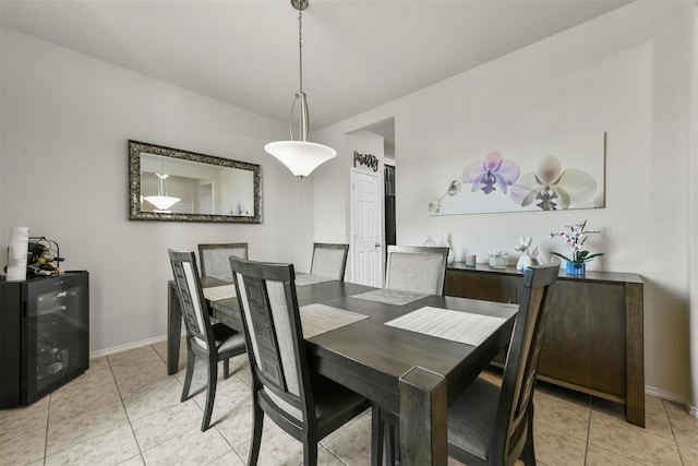 dining room with light tile patterned floors and baseboards