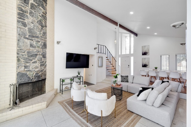 living room featuring high vaulted ceiling, a fireplace, stairway, tile patterned floors, and beamed ceiling