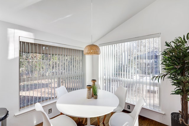 dining space with a wealth of natural light and vaulted ceiling