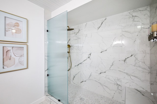 full bathroom featuring a marble finish shower