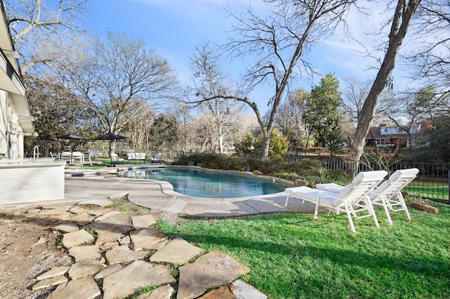 view of pool with a fenced in pool, a patio area, fence, and a lawn