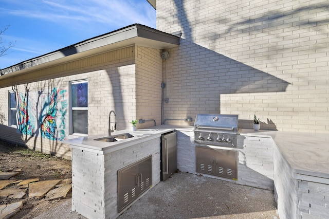 view of patio / terrace with an outdoor kitchen, grilling area, and a sink