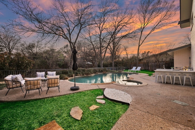 view of swimming pool featuring a patio, a fenced backyard, an outdoor living space, outdoor dry bar, and a fenced in pool