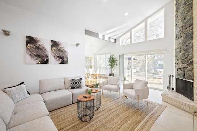 living room featuring a fireplace and high vaulted ceiling