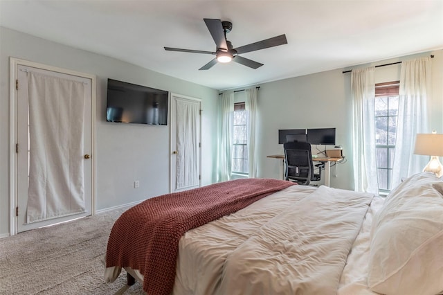 bedroom featuring carpet, baseboards, two closets, and ceiling fan