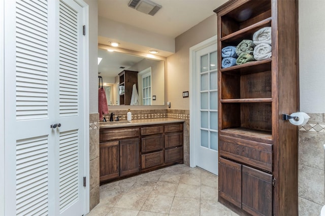 bathroom with tile patterned floors, visible vents, and vanity