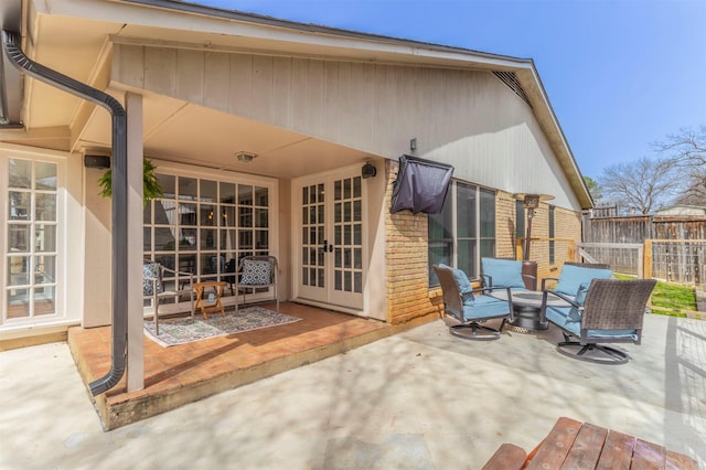 view of patio featuring french doors and fence