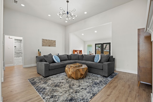 1607 Amesbury Ln, Rockwall, TX 75087 - living room with light wood-type flooring, recessed lighting, baseboards, and a chandelier