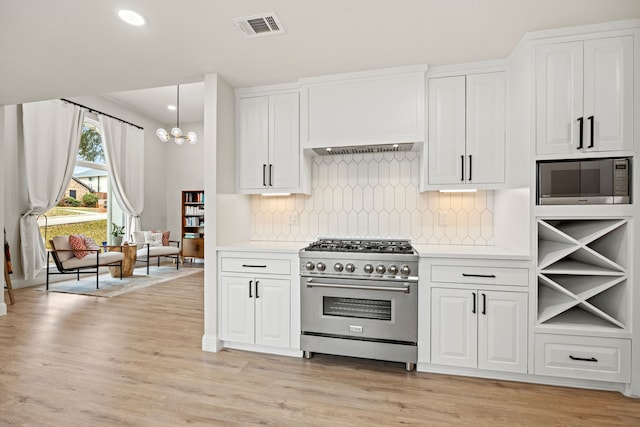 1607 Amesbury Ln, Rockwall, TX 75087 - kitchen featuring high end stainless steel range, built in microwave, light countertops, white cabinetry, and recessed lighting