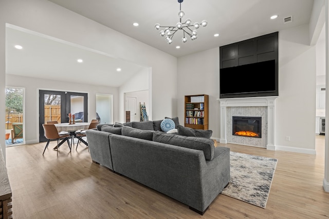 1607 Amesbury Ln, Rockwall, TX 75087 - living area with light wood-style flooring, recessed lighting, a fireplace, a chandelier, and lofted ceiling