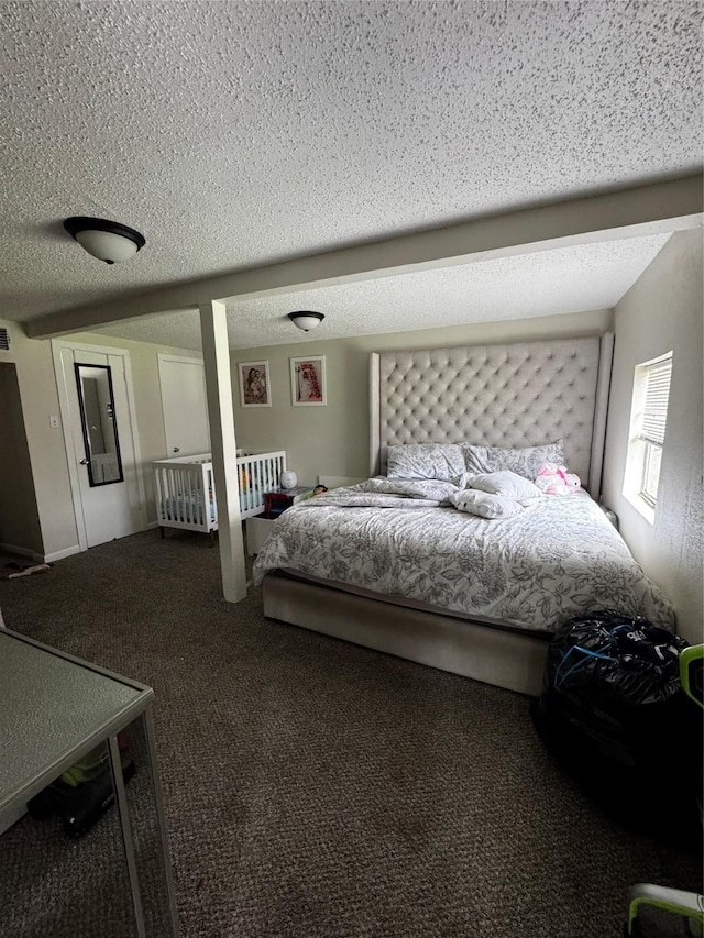 bedroom featuring a textured ceiling and carpet floors