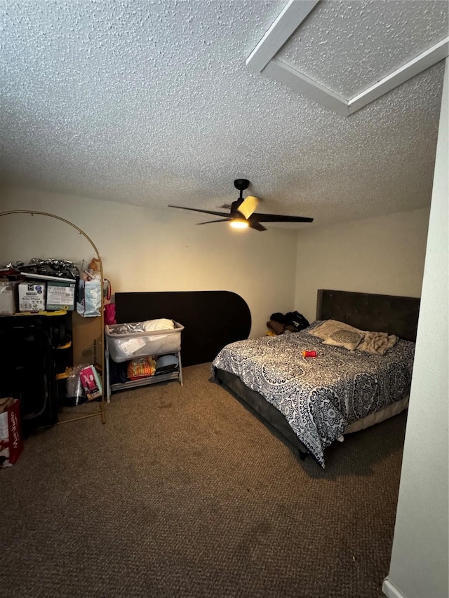 carpeted bedroom with a textured ceiling and ceiling fan