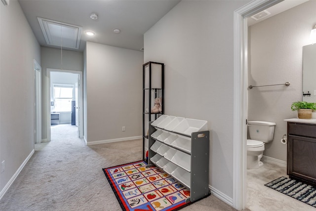 interior space featuring vanity, toilet, baseboards, and visible vents