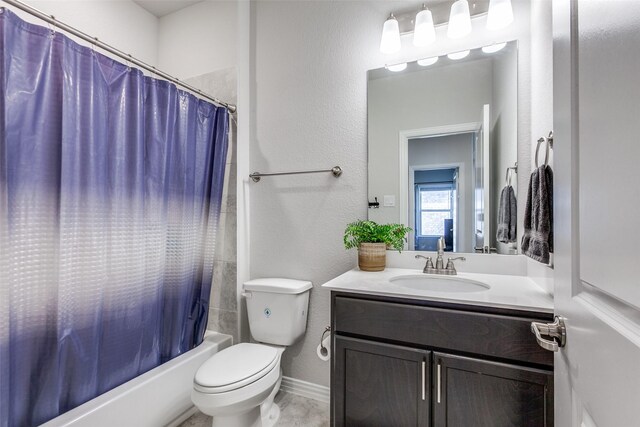 full bathroom with vanity, baseboards, shower / bath combo, toilet, and a textured wall