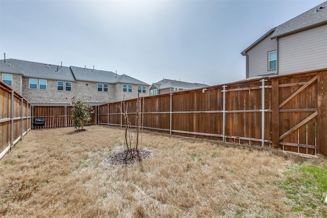 view of yard with a fenced backyard