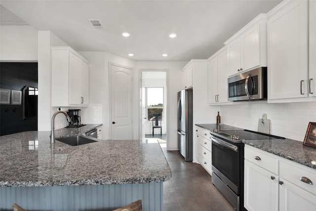 kitchen with visible vents, appliances with stainless steel finishes, white cabinets, and a sink