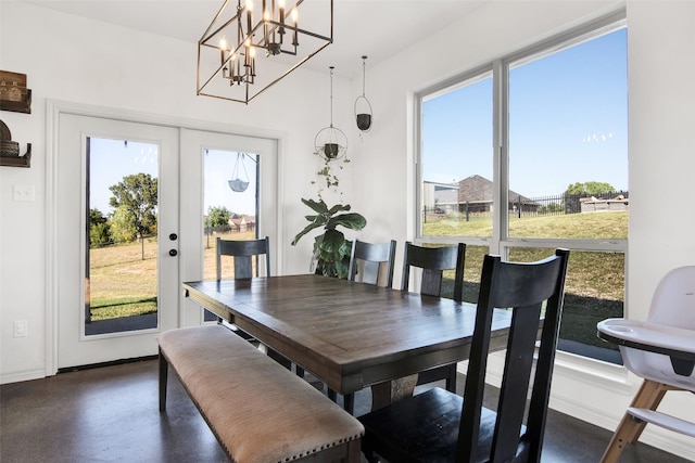 dining area featuring concrete floors, baseboards, and french doors