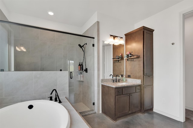 bathroom featuring a stall shower, vanity, concrete flooring, baseboards, and a bath