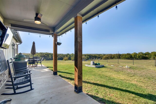 view of patio / terrace with fence, outdoor dining area, and a ceiling fan