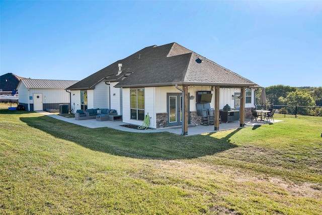 rear view of house with central AC, a patio, an outdoor living space, and a lawn